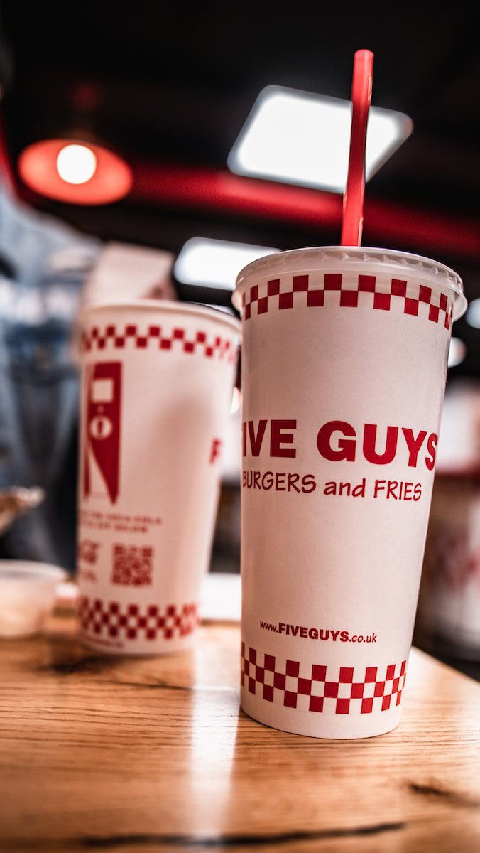 five guys cups on wooden table